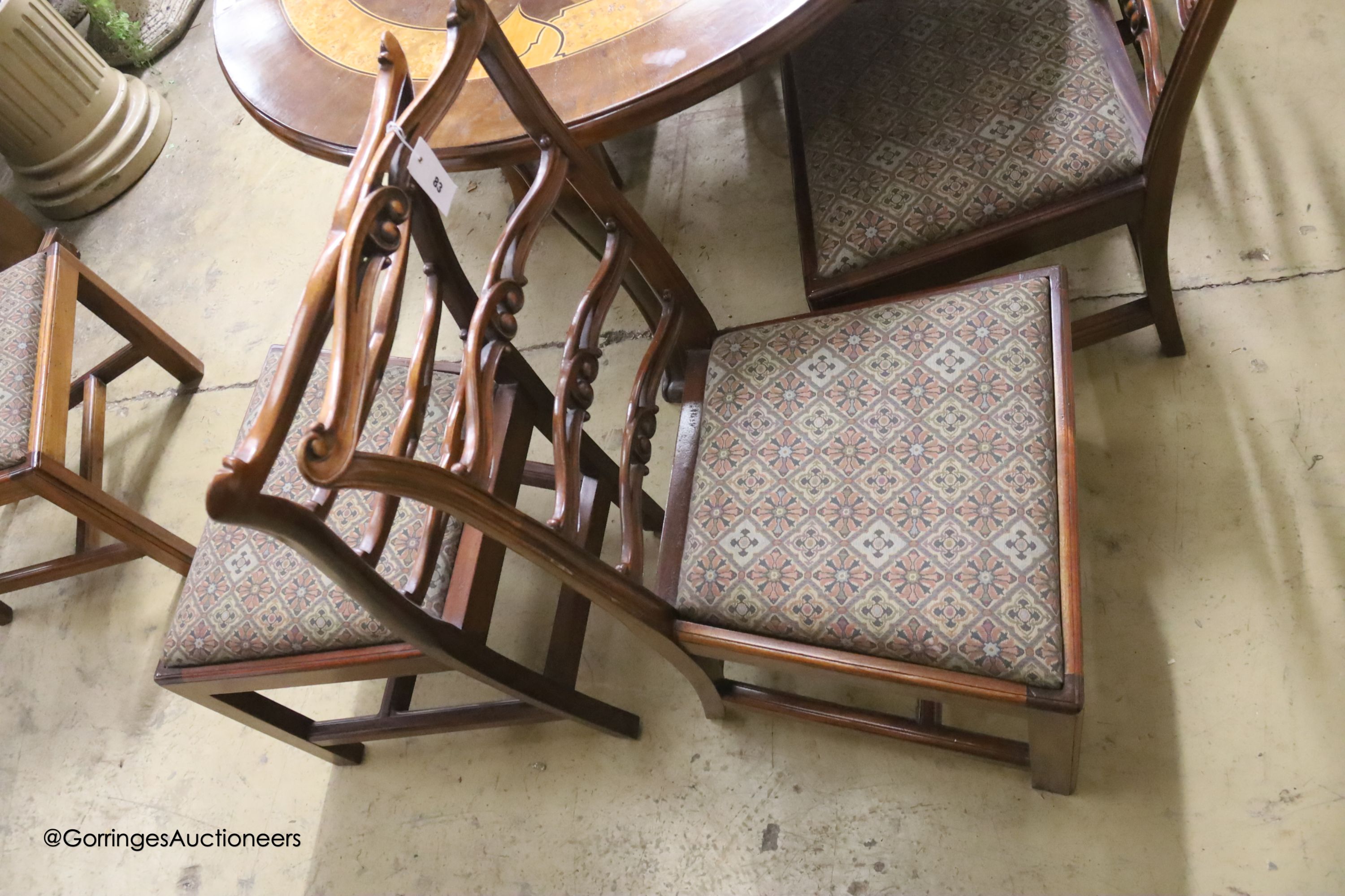 A set of six George III style mahogany pierced ladderback dining chairs